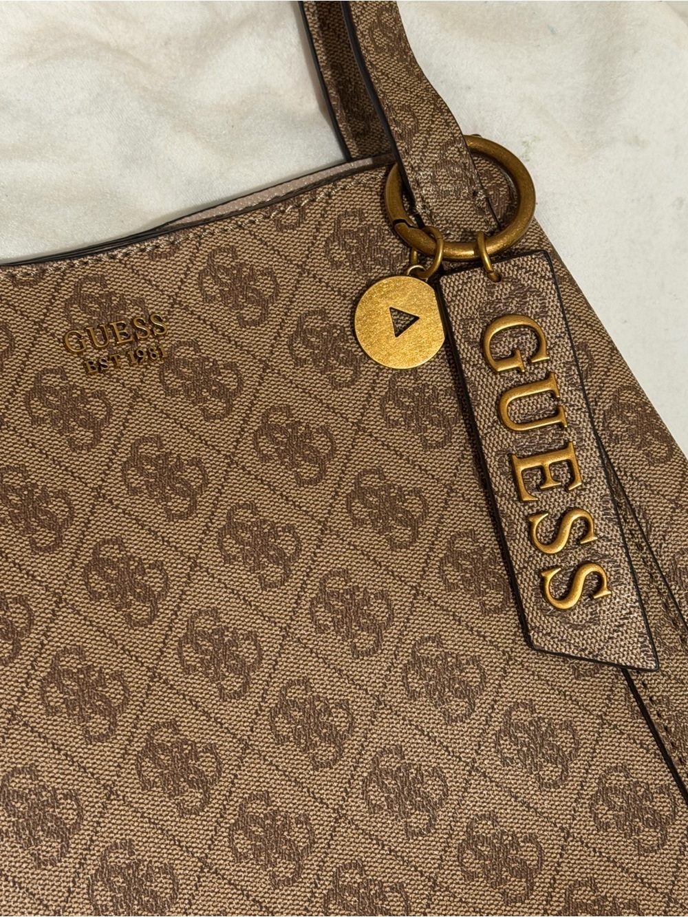 GUESS Naya tote bag featuring an all over 4G monogram print and a vertical zip